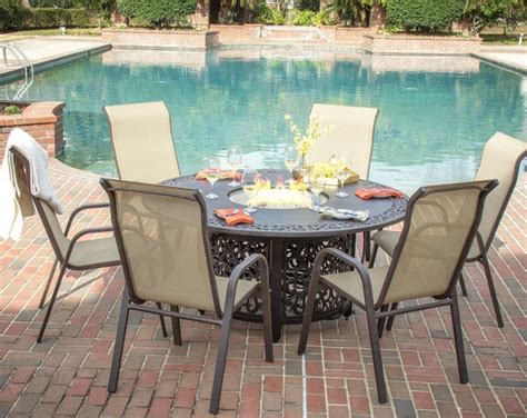 Round brick fire pit surrounded by a row of tiny gravel built in the middle of the grass in the backyard. Madison Bay 7 Piece Sling Patio Dining Set With Fire Pit ...