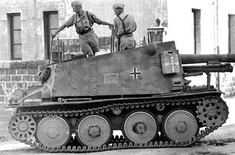 Two Men Standing On Top Of An Old Tank