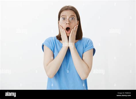 Portrait Of Impressed And Surprised Attractive Woman With Fair Hair In Glasses Dropping Jaw