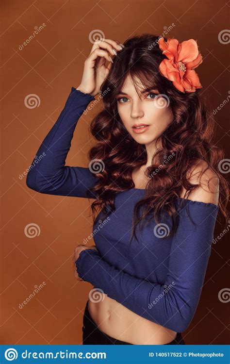 Young Beautiful Woman With Flowers In Her Hair And Makeup Toning Photo