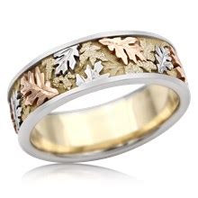 The center row has a leaf motif filigree set with diamonds. Leaf and Vine Wedding Rings
