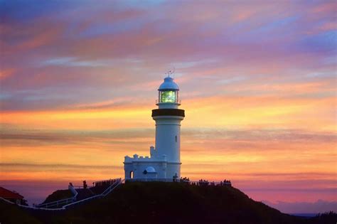 The byron bay lighthouse is iconic of byron bay, perched high on the headland overlooking the bay. First Sun NYD 2019, a dawn ceremony at Cape Byron ...