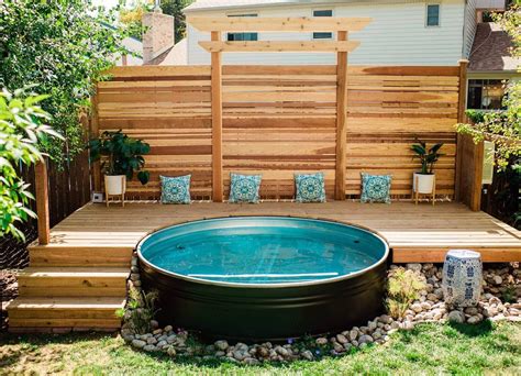 An Above Ground Pool Surrounded By Wooden Decking And Seating Area In