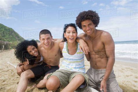 Multi Ethnic Friends Hugging At Beach Stock Photo Dissolve