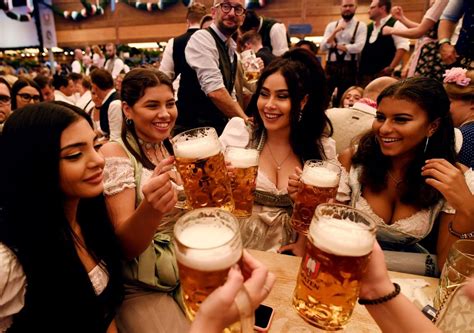 visitors cheer with beers during the opening day of the 185th oktoberfest in munich showccasion