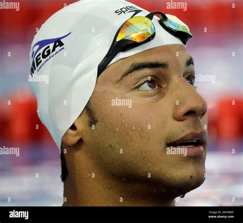 Olympic Refugee Team Member Rami Anis Talks With His Coach As He Swims