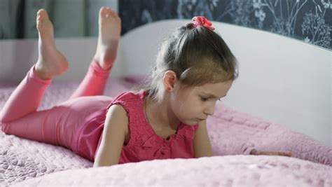 Little Girl Lying On Bed Playing Stock Footage Video 100 Royalty Free