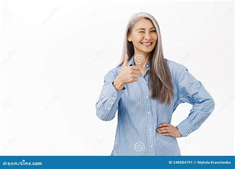 cheerful asian senior woman japanese granny showing thumbs up in approval likes product