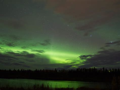 Aurora Borealis Behind Some Clouds Reflecting Off A Lake Smithsonian