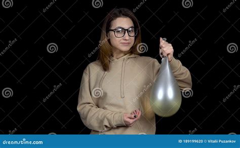 Young Woman Shakes Balls With Water Girl Shakes The Ball On A Black Background The Balloon