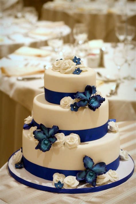 i love the blue orchids and white roses on this orchid wedding cake royal blue wedding cakes