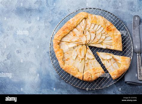 Apple Galette Pie Tart With Cinnamon On Cooling Rack On A Blue Stone