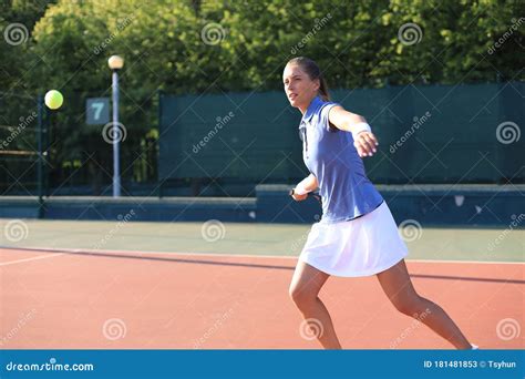 professional equipped female tennis player beating hard the tennis ball with racquet stock image