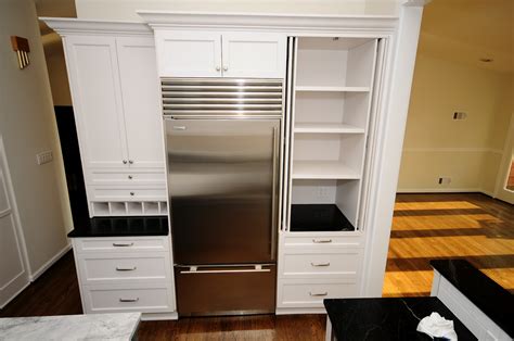 Beautiful kitchen features cabinet s filled with a flatscreen tv finished with retractable cabinet doors stacked above an integrated microwave next to pecky cypress bi fold pantry doors. Cherry Hill Cabinetry: Soapstone and White Painted ...