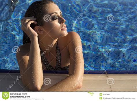 Woman With Long Hair In Bikini Relaxing In Swimming Pool Royalty Free Stock Photography