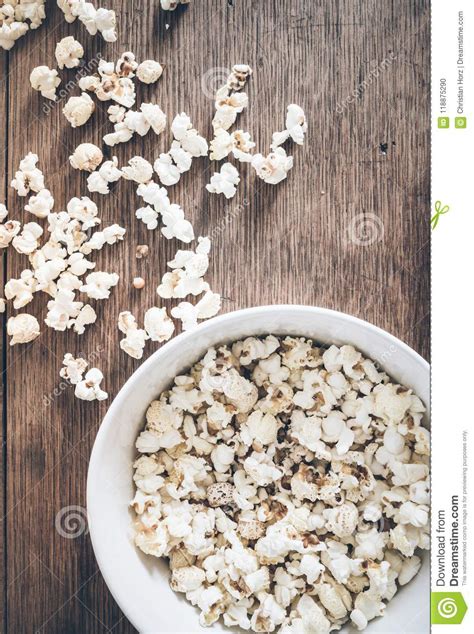 Directly Above Shot Of Bowl Filled With Popcorn And Spilled Popcorn On