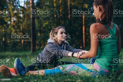 Two Girls Doing Partner Stretching Yoga Exercise Paschimottanasana Or