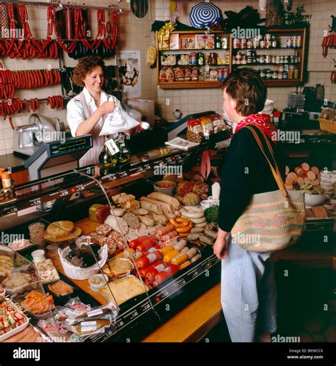 German Woman Buying Meats At A Local Metzgerei Truffner Butcher Stock