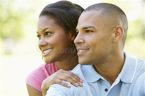 Portrait Of Romantic Young African American Couple In Park Stock Photo