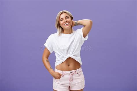 Indoor Shot Of Carefree Relaxed And Joyful Attractive Athletic Blonde Woman In Trendy Summer
