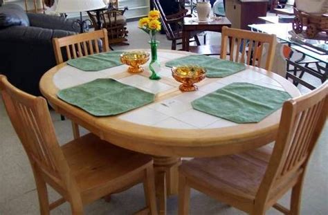 An oak leaf cluster is a ribbon device to denote subsequent decorations and awards consisting of a miniature bronze or silver twig of four oak leaves with three acorns on the stem. Oak tile-top table w/ leaf and four chairs. 42" in ...