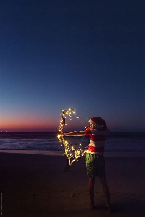 Playing With Christmas Lights At The Beach After Sunset By Stocksy Contributor Angela Lumsden