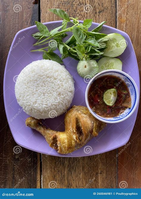 Pecel Ayam Made From White Rice Fried Chicken With Fresh Vegetable And