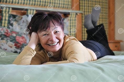 Senior Woman Relaxing On Bed Stock Image Image Of Healthy Lying 8841549