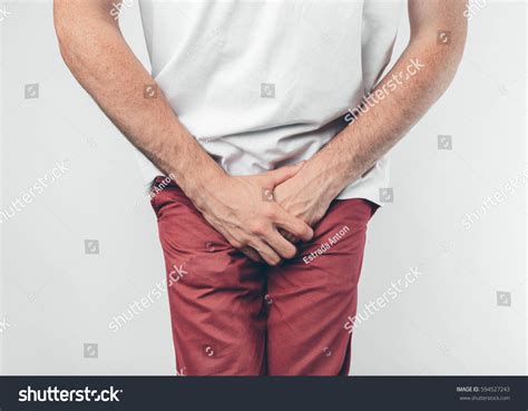 Man Holding His Penis On White