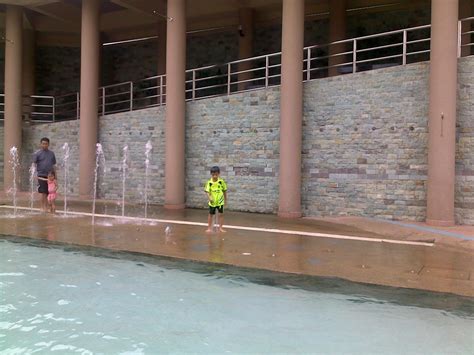 While the large swimming pool to the back of the plantation is reserved for guests, the smaller red pool lounge area at the front is open to outside visitors. My Family Story: @ Swimming Pool Presint 9, Putrajaya