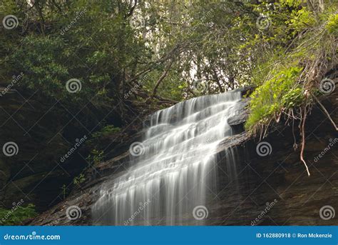 Close Up Of Silky Smooth Waterfalls Flowing Across Rocks Stock Photo