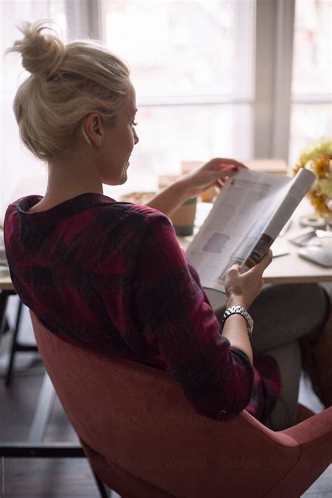 Businesswoman Reading A Magazine At The Office By Stocksy Contributor Lumina Stocksy