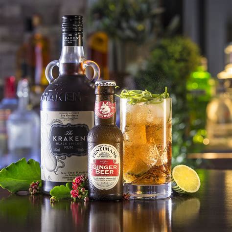 Cold moscow mules cocktail with ginger beer, vodka, lime grey stone background copy space. The Perfect Storm - 50ml Kraken Rum, 125ml Ginger Beer garnished with lime. Delicious! trong ...