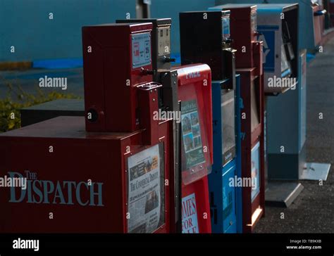 A row of newspaper racks stands in downtown Columbus, Mississippi