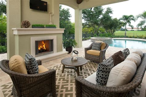 Elegant living room with red sofa, fireplace, tv and many windows. Beasley & Henley Interior Design Unveils Interior Design ...