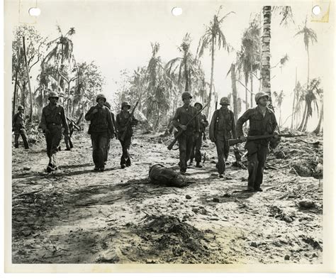 7th Infantry Division Soldiers Walk Past The Dead Body Of Fellow