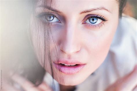 Portrait Of A Beautiful Young Woman With Black Hair And Blue Eyes By