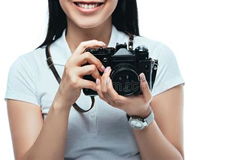 view of smiling brunette asian woman taking picture on digital camera isolated on white stock