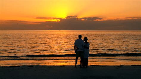 Contented Senior Couple Enjoying A Romantic Sunset Evening