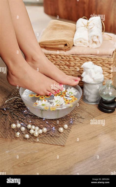 Pedicured Feet Of Young Woman Over Bowl With Hot Water Aroma Oil And