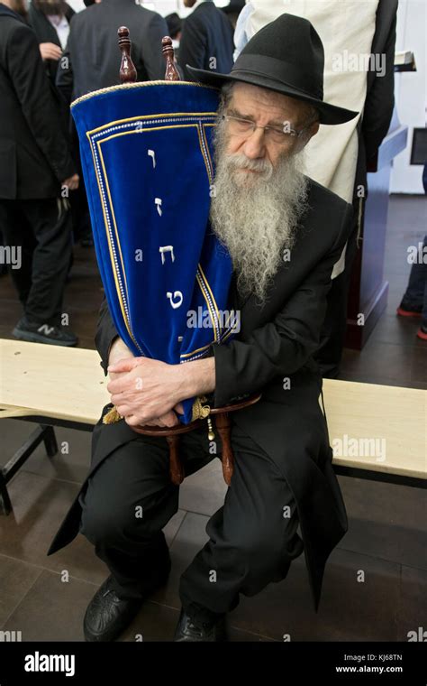 An Orthodox Hasidic Rabbi Holds A Torah Scroll After It Was Read And