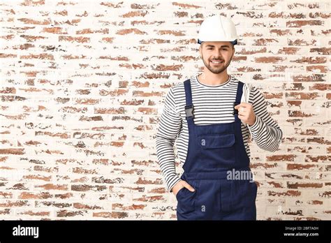 Handsome Male Worker On Brick Background Stock Photo Alamy