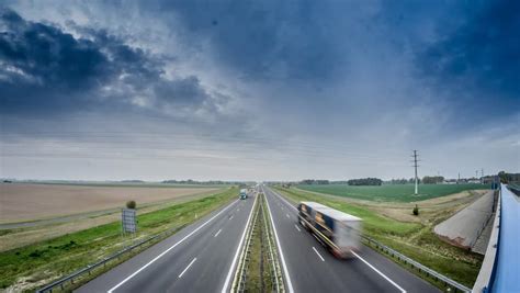 Two Lane Highway With Fast Moving Clouds Above Stock Footage Video