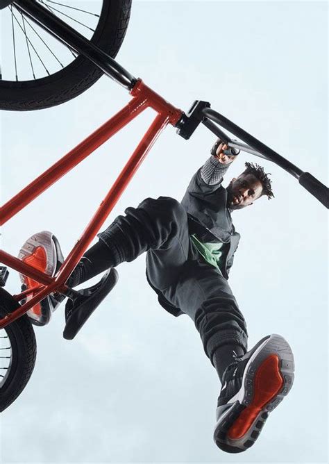 A Man Flying Through The Air While Riding A Skateboard On Top Of A Bike