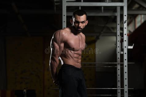 Muscular Man Flexing Muscles In Gym Stock Photo Image Of Center
