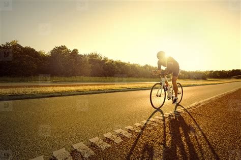 Fit Person Riding A Bike In Sunset Stock Photo 136051 Youworkforthem