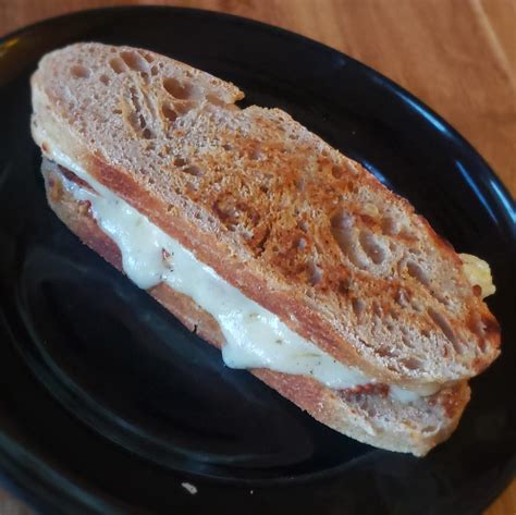 Guacamole, bacon, cheddar, tomato and onion sandwich. My neighbor gave me a loaf of homemade sourdough so I turned it into a sandwich, of course, with ...