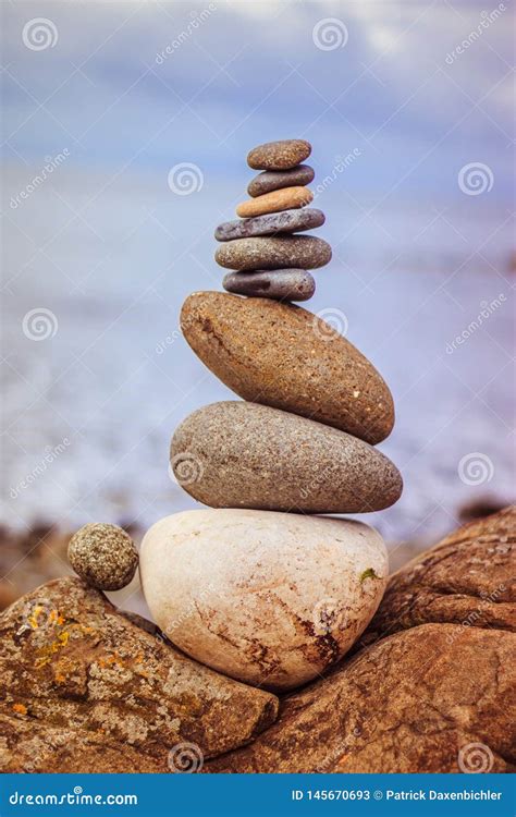Balance Relaxation And Wellness Stone Cairn Outside Ocean In The Blurry Background Stock