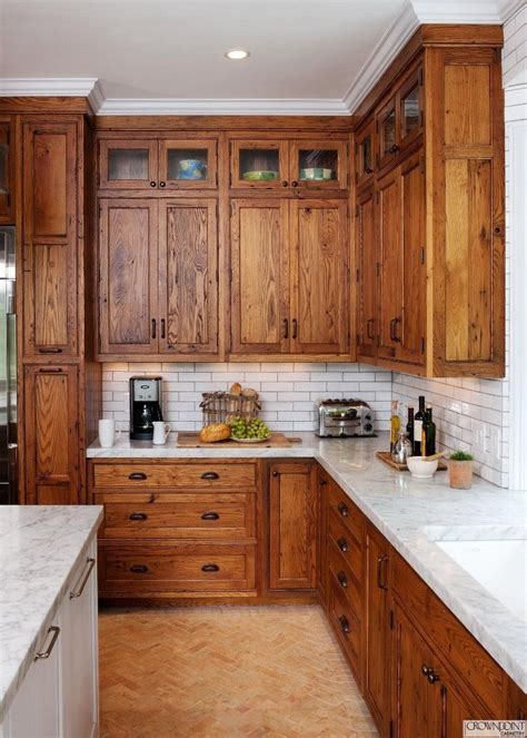 The ornate wood hood above the cooktop. Image result for oak cabinets and white quartz countertop ...