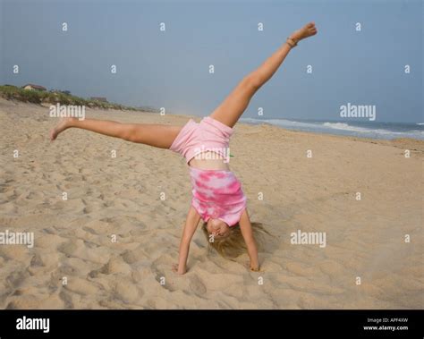 Child Doing A Handstand On The Beach Stock Photo Alamy